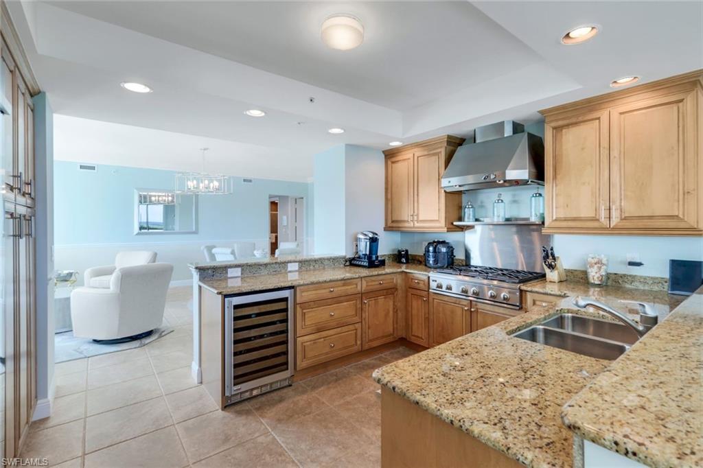 275 Indies Way, Unit 706 Naples, FL 34110 - Photo 11 of 50 a kitchen with a stove a sink a counter space and cabinets