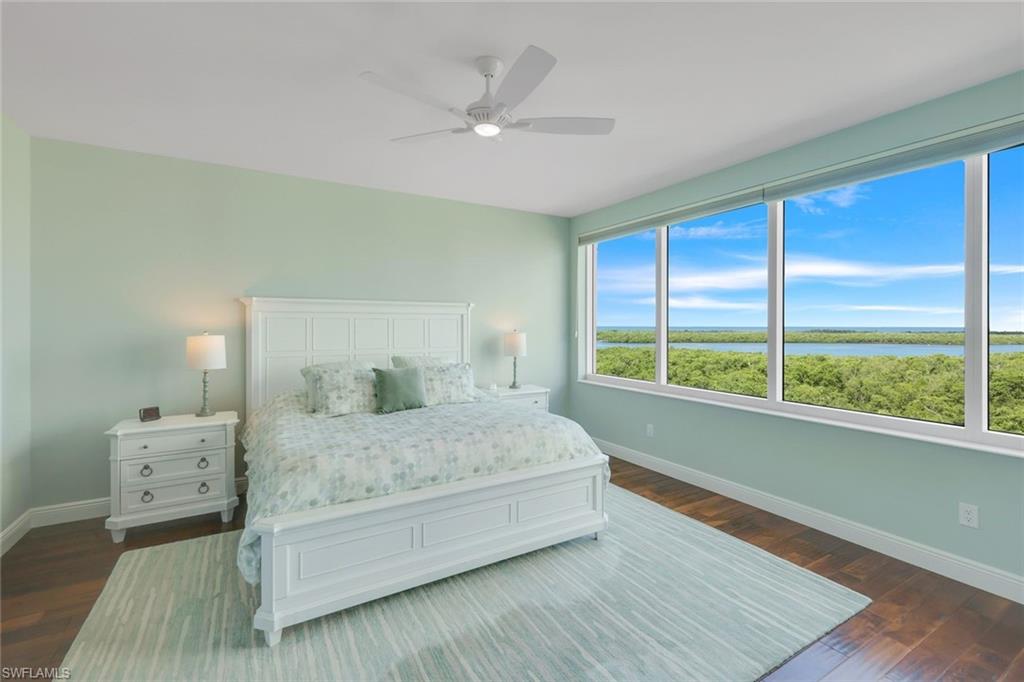 275 Indies Way, Unit 706 Naples, FL 34110 - Photo 18 of 50 a bedroom with a large bed and a large window