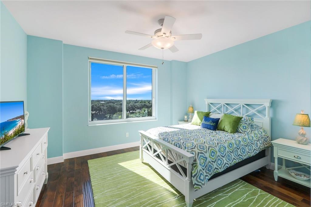 275 Indies Way, Unit 706 Naples, FL 34110 - Photo 23 of 50 a bedroom with a bed and a chandelier