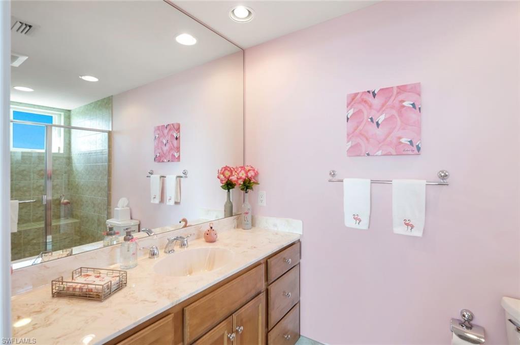 275 Indies Way, Unit 706 Naples, FL 34110 - Photo 26 of 50 a bathroom with a sink vanity and a mirror