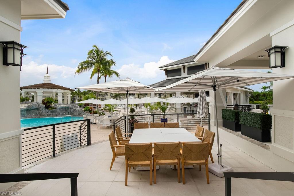275 Indies Way, Unit 706 Naples, FL 34110 - Photo 50 of 50 a view of a patio with a table and chairs