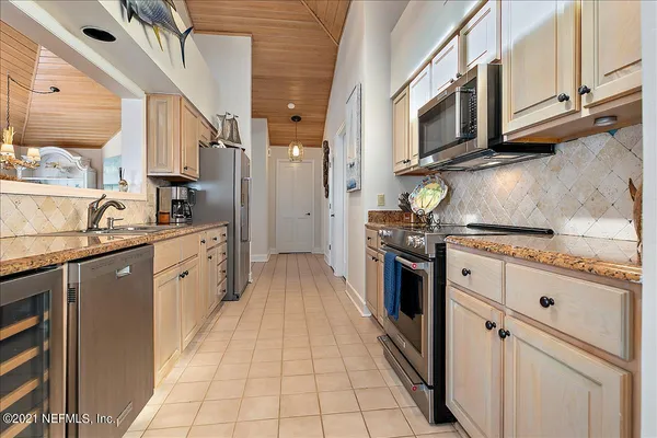 a kitchen with stainless steel appliances a refrigerator and a stove