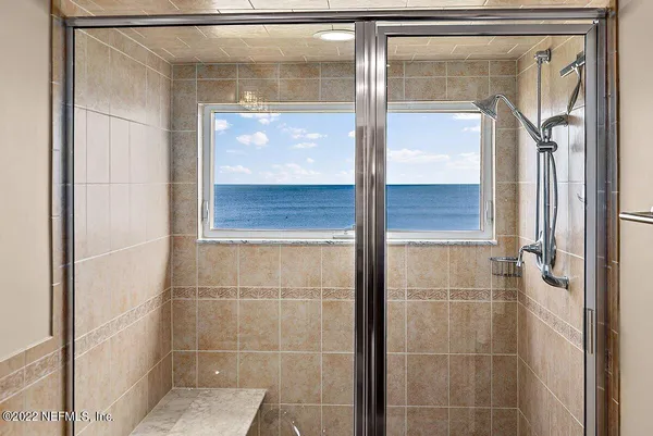 a bedroom with a bed couches and a flat tv screen