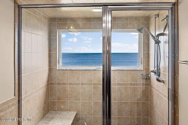 a bedroom with a bed couches and a flat tv screen