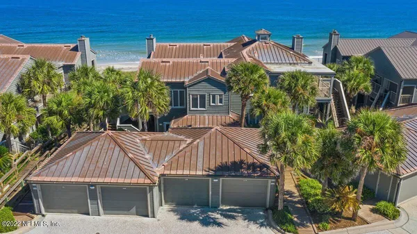 a view of a house with brick walls and plants