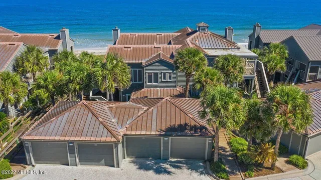 a view of a house with brick walls and plants