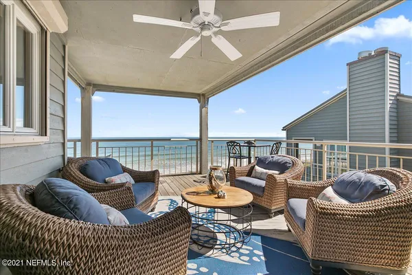 a living room with furniture and floor to ceiling window