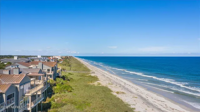 a front view of house with yard and lake view