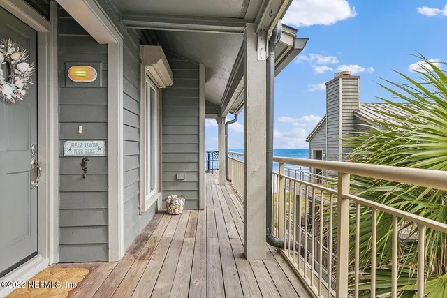 a view of balcony with wooden floor and fence