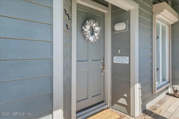 a room with gym equipment and wooden floor
