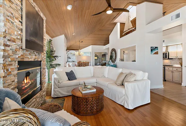 a living room with fireplace furniture and a wooden floor