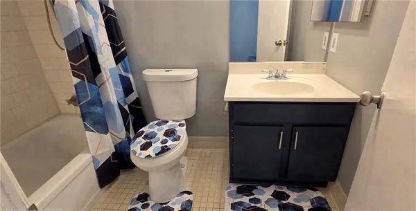 a bathroom with a sink and mirror with toilet