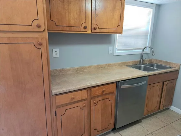 a kitchen with granite countertop cabinets and sink