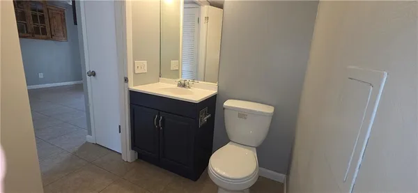 a bathroom with a toilet a sink and mirror