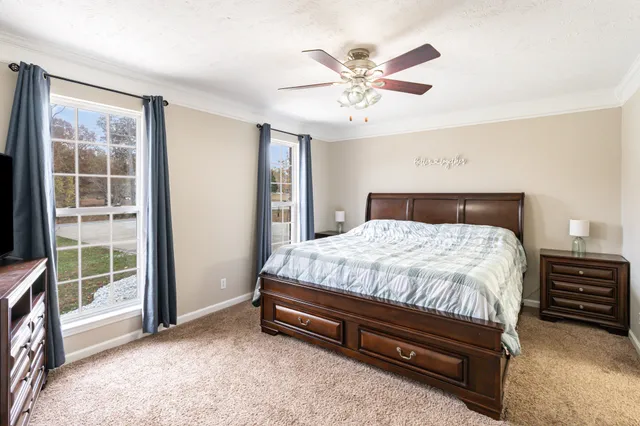 a spacious bedroom with a bed and a chandelier