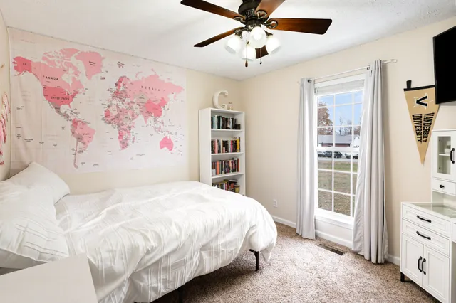 a bedroom with a large bed and a window