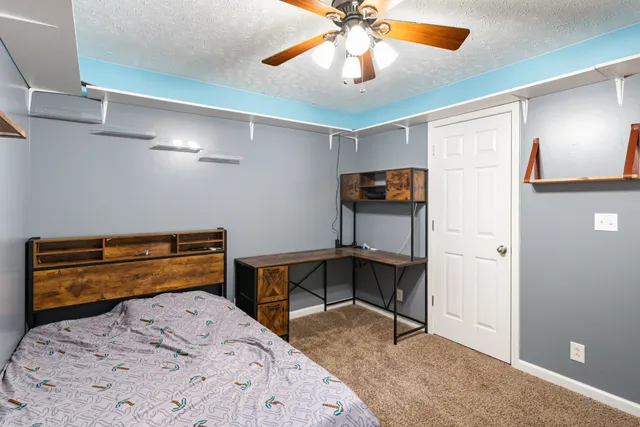 a bedroom with a bed and a chandelier