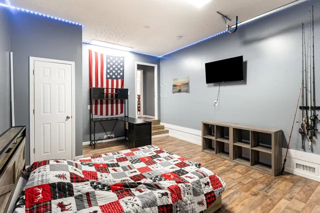 a bedroom with a bed and a flat screen tv