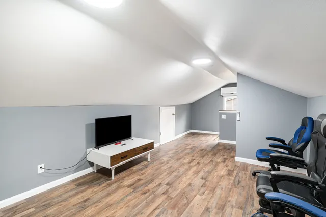 a bedroom with a bed and flat screen tv