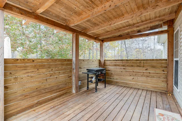 a view of a room with wooden floor and furniture