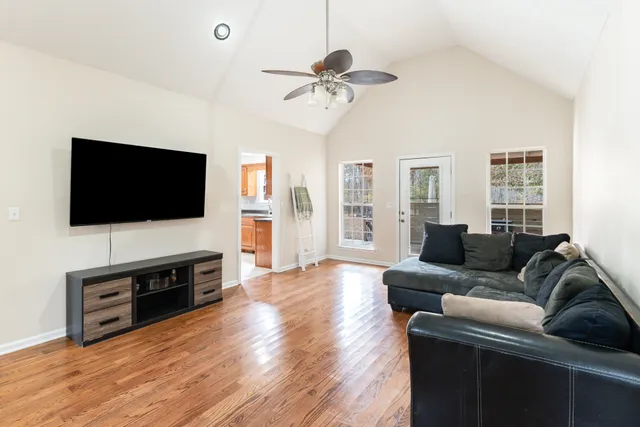 a living room with furniture and a flat screen tv