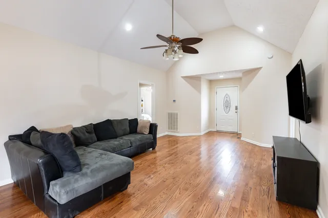 a living room with furniture and a flat screen tv