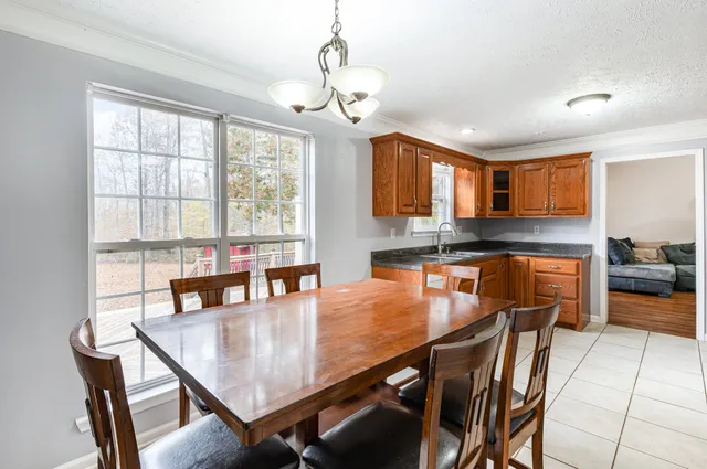 a view of a dining room with furniture window and outside view