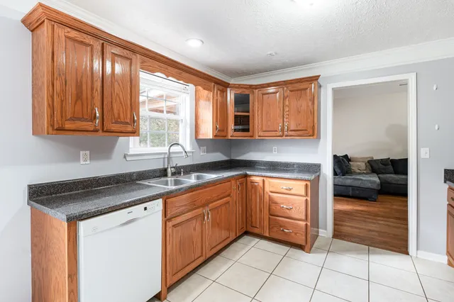 a kitchen with stainless steel appliances granite countertop a sink and cabinets