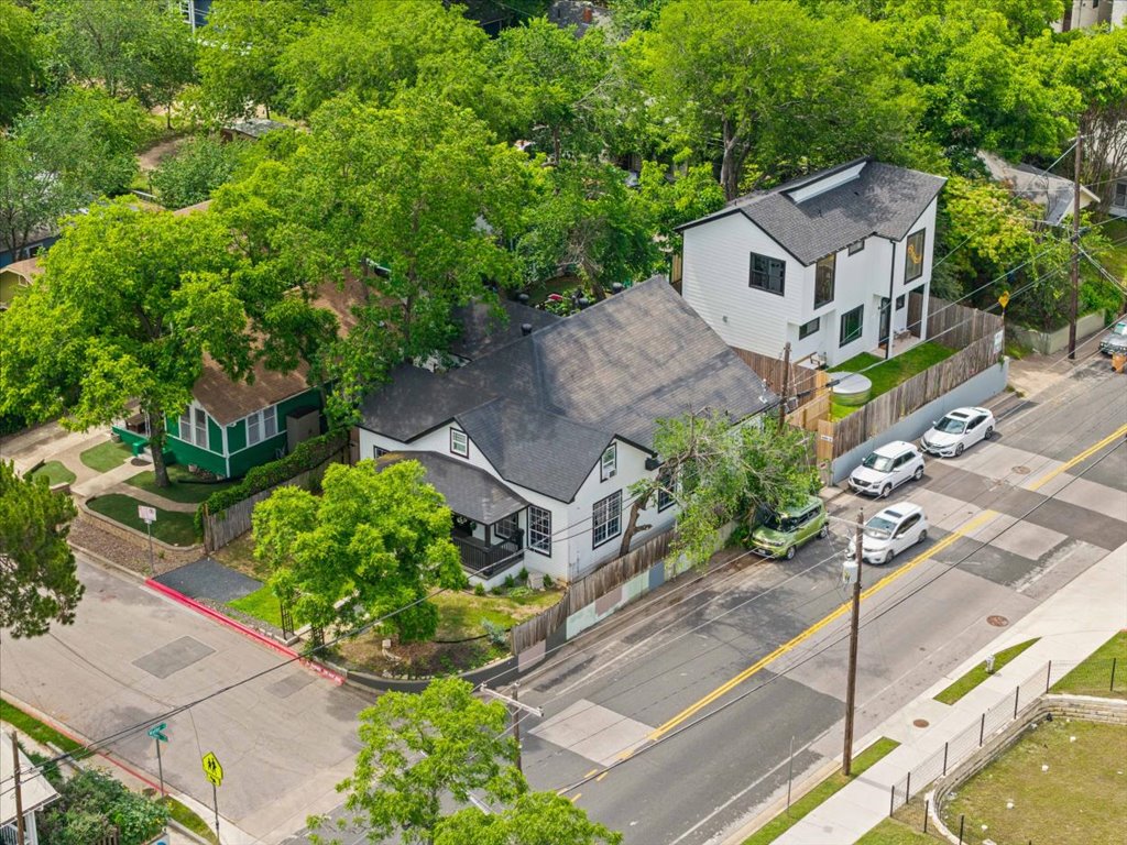 1201 Garden Street, Unit A Austin, TX 78702 - Photo 24 of 30 White exterior with black trim, featuring a dark shingle roof and front porch entry
