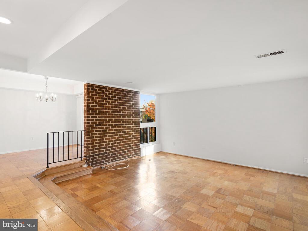 2109 Walsh View Terrace, Unit 12203 Silver Spring, MD 20902 - Photo 6 of 23 Stepdown to Den; Exposed Brick Wall