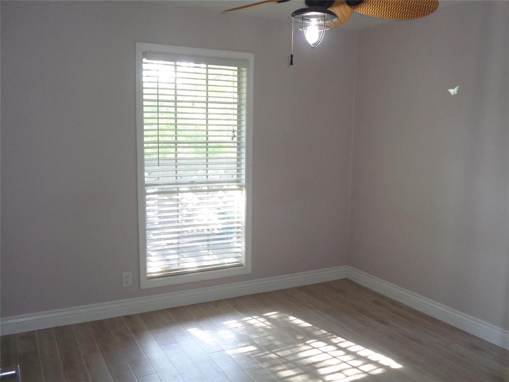 5048 Heatherhill Lane, Unit 1204 Boca Raton, FL 33486 - Photo 16 of 31 a view of an empty room with wooden floor and a window