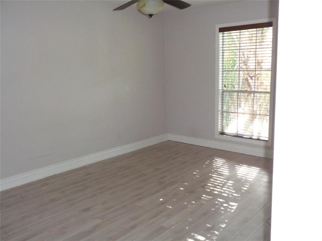 5048 Heatherhill Lane, Unit 1204 Boca Raton, FL 33486 - Photo 18 of 31 a view of empty room with wooden floor and fan