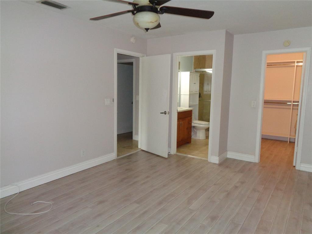 5048 Heatherhill Lane, Unit 1204 Boca Raton, FL 33486 - Photo 19 of 31 a view of an empty room with wooden floor