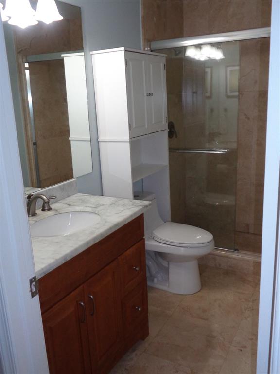 5048 Heatherhill Lane, Unit 1204 Boca Raton, FL 33486 - Photo 20 of 31 a bathroom with a granite countertop sink toilet and shower