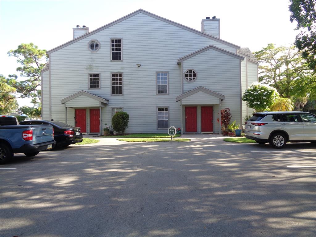5048 Heatherhill Lane, Unit 1204 Boca Raton, FL 33486 - Photo 2 of 31 a view of a car park in front of house