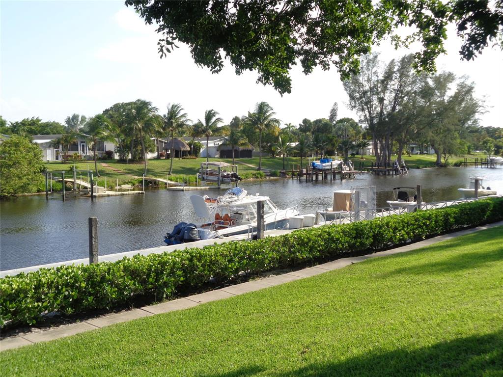 5048 Heatherhill Lane, Unit 1204 Boca Raton, FL 33486 - Photo 30 of 31 a view of a lake with a house in the background