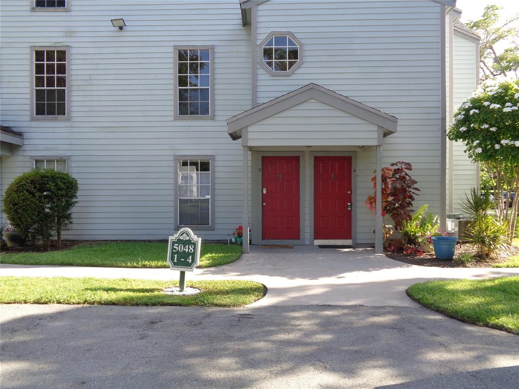 5048 Heatherhill Lane, Unit 1204 Boca Raton, FL 33486 - Photo 3 of 31 a front view of a house with garden