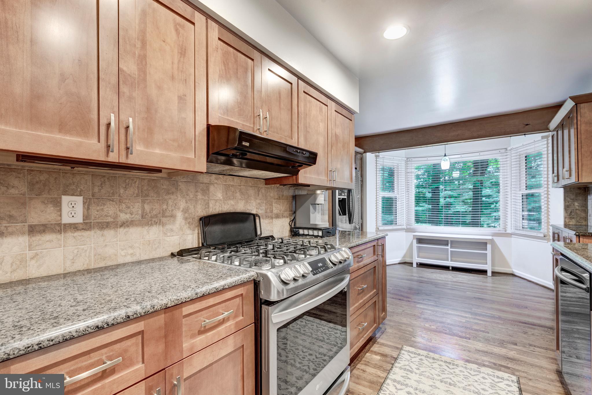 1425 Ridge Road Westminster, MD 21157 - Photo 10 of 44 a kitchen with stainless steel appliances kitchen island granite countertop a sink stove and cabinets
