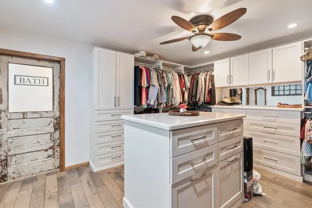 a view of walk in closet with clothes and shoes