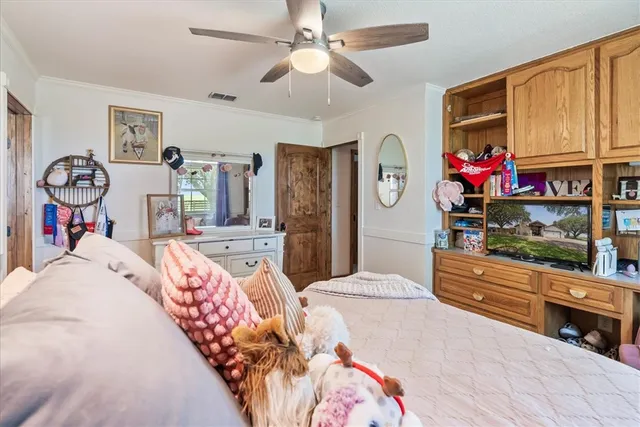 a bed room with a bed mirror and a dresser