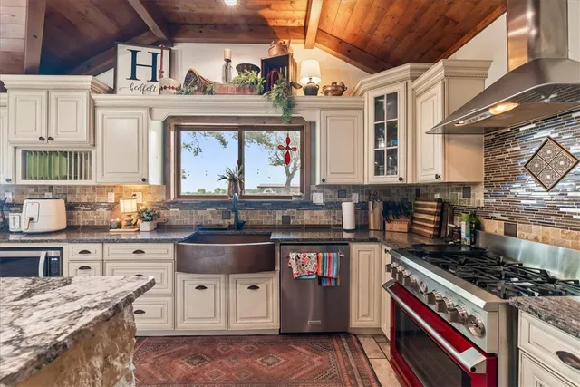 a kitchen with stainless steel appliances granite countertop a stove and a sink