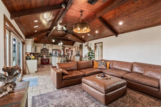 a living room with furniture and a chandelier