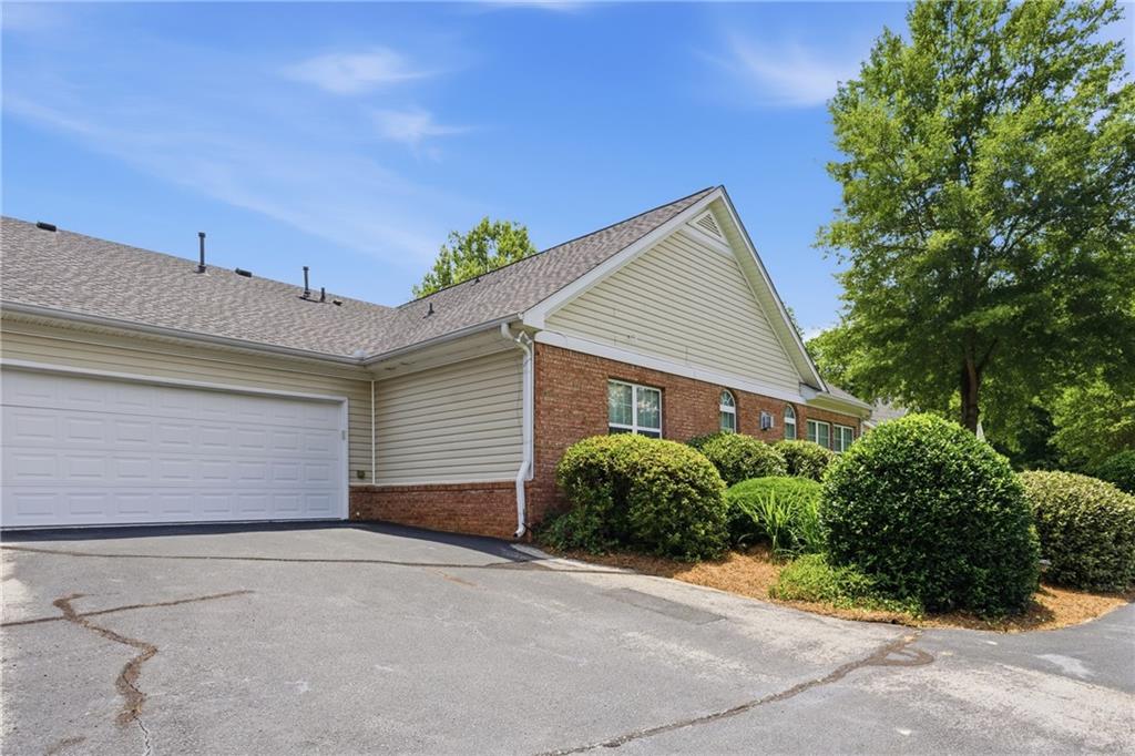 4533 Caleb Crossing, Unit 18 Powder Springs, GA 30127 - Photo 23 of 24 a front view of a house with a yard and garage