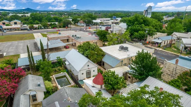 an aerial view of multiple houses with a street