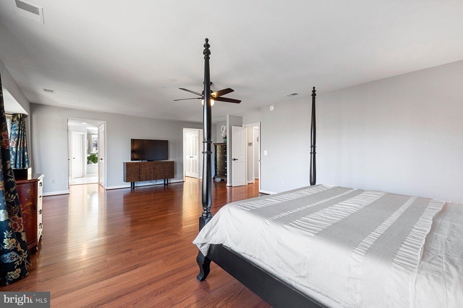 20623 Cutwater Place Sterling, VA 20165 - Photo 27 of 59 a spacious bedroom with a bed and a flat screen tv