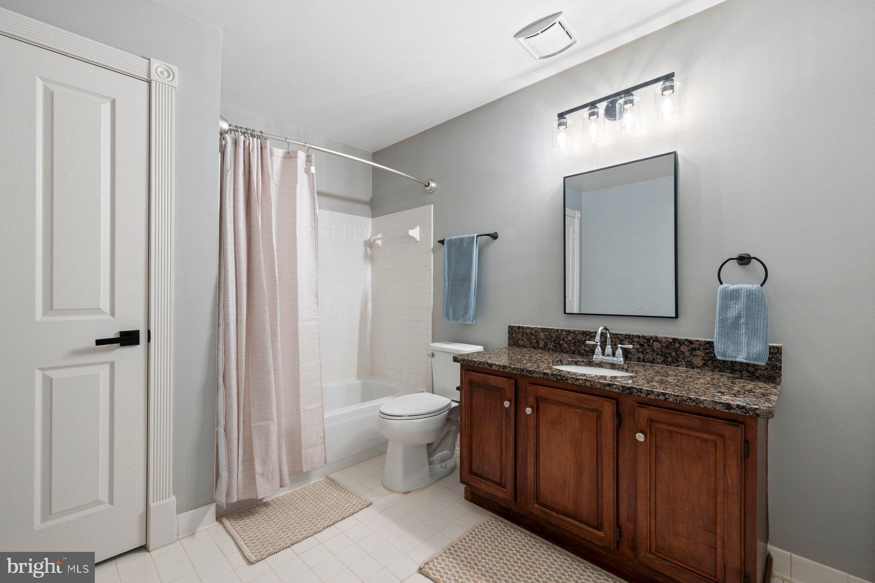 20623 Cutwater Place Sterling, VA 20165 - Photo 45 of 59 a bathroom with a granite countertop sink toilet and shower