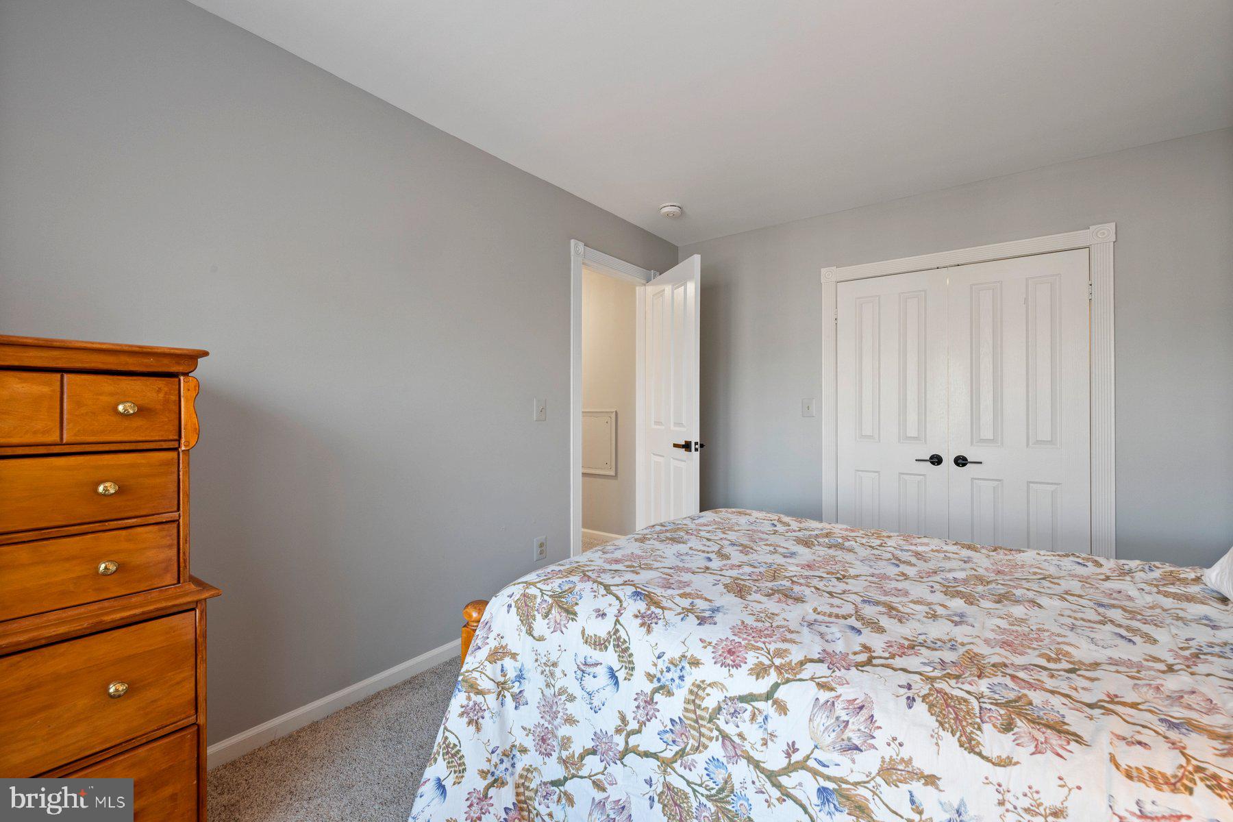 20623 Cutwater Place Sterling, VA 20165 - Photo 47 of 59 a bedroom with a bed and a dresser