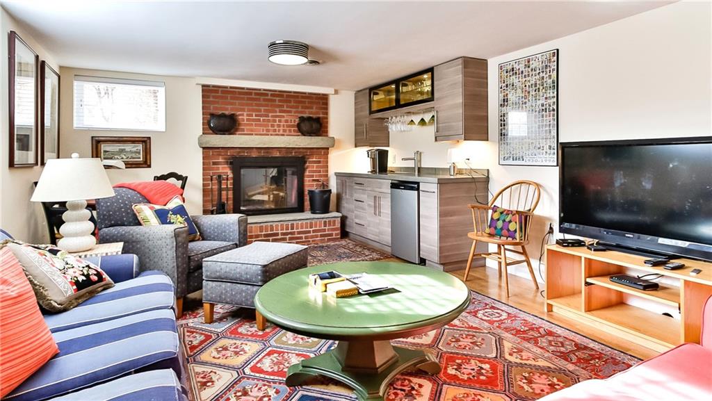 172 Mayfair Drive Pittsburgh, PA 15228 - Photo 17 of 25 a living room with furniture a flat screen tv and a fireplace