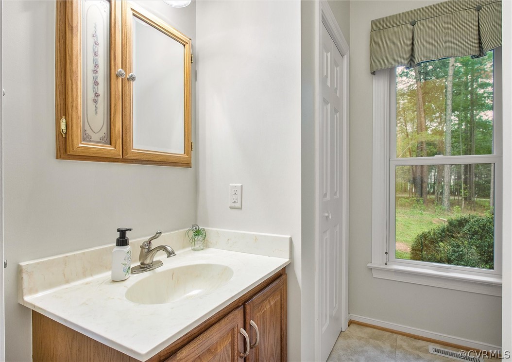2763 Checketts Drive Sandy Hook, VA 23153 - Photo 24 of 36 a bathroom with a sink vanity and a mirror