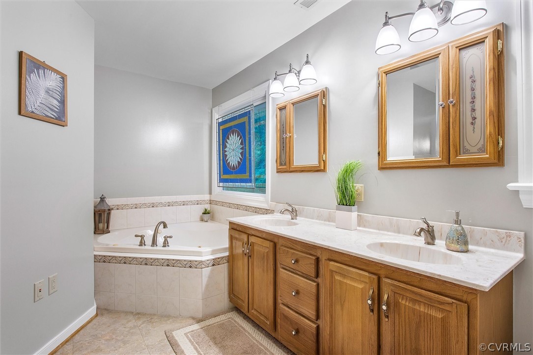 2763 Checketts Drive Sandy Hook, VA 23153 - Photo 29 of 36 a bathroom with a double vanity sink mirror and bathtub